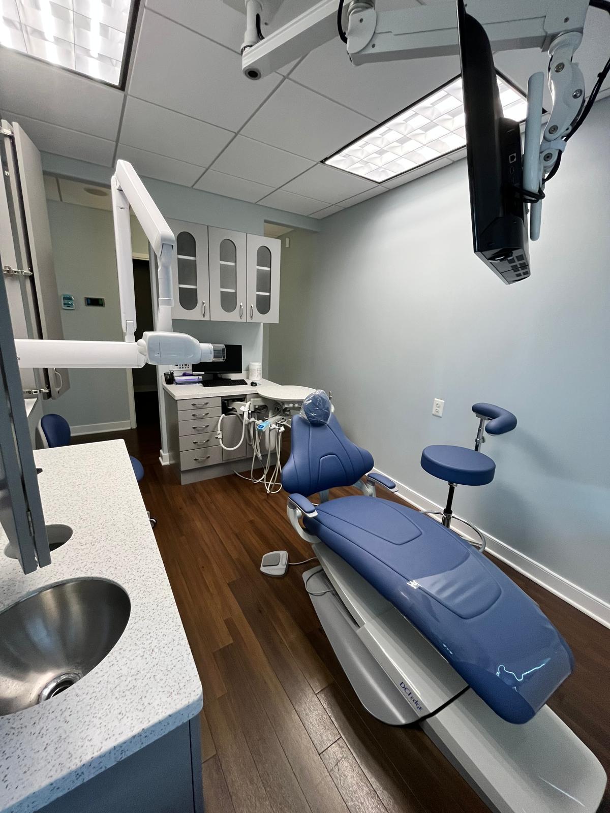 Modern blue dental chair and treatment room